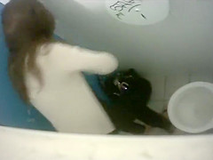 Long-haired brunette with a bubble butt takes a quick pee in the college restroom