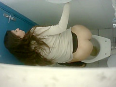 Long-haired brunette with a bubble butt takes a quick pee in the college restroom