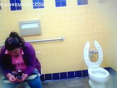 Mature Mexican woman goes pee in a public bathroom