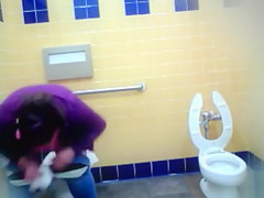 Mature Mexican woman goes pee in a public bathroom