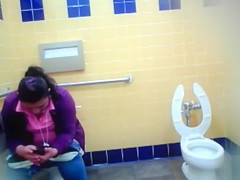 Mature Mexican woman goes pee in a public bathroom