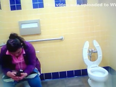 Mature Mexican woman goes pee in a public bathroom
