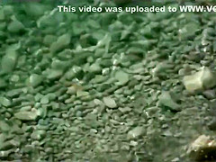   Mature woman have sex with a man at a public beach