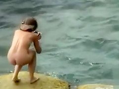 Nudist family alone on the beach relaxes all day