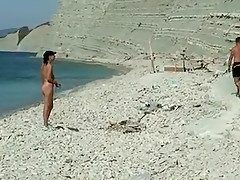 Outdoor shot of nude babe on beach