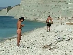 Outdoor shot of nude babe on beach