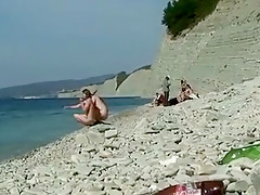 Outdoor shot of nude babe on beach