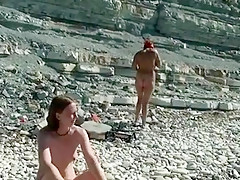 Outdoor shot of nude babe on beach