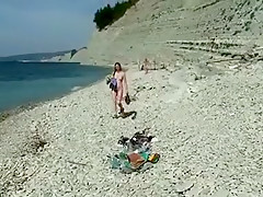 Outdoor shot of nude babe on beach