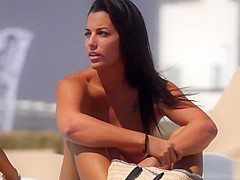Perfect tanned babe show off her tits on the beach