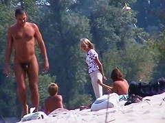 Perky breasted nude beach MILF filmed by a
