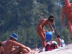 Perky breasted nude beach MILF filmed by a