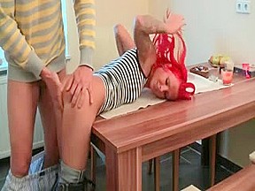 Redhead slut fucks on the table