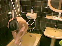 Skinny girl soaps up her beautiful body