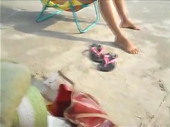 Spouse filming his wife on the beach