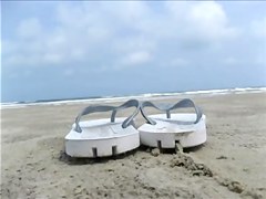 Spouse filming his wife on the beach
