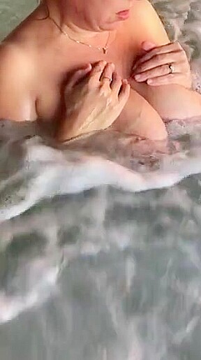 Tit play in hot tub