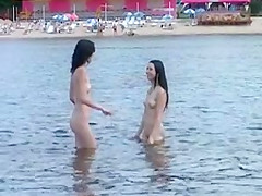 Two skinny nudist teens 18+ frolic around the beach