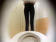Woman takes a leak in toilet