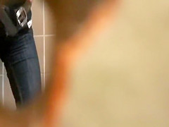 Woman takes a pee in public toilet