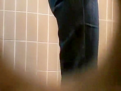 Woman takes a pee in public toilet