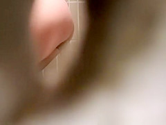 Woman takes a pee in public toilet