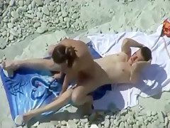 tapes a couple having sex in various positions on a nude beach