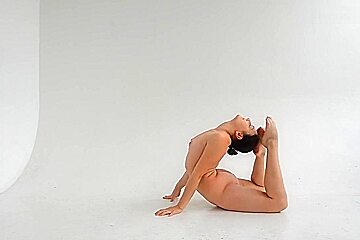 young nude gymnast twisting her well shaped body 