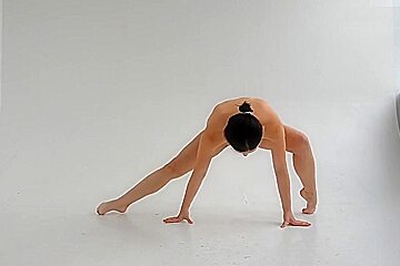 young nude gymnast twisting her well shaped body 