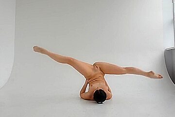 young nude gymnast twisting her well shaped body 