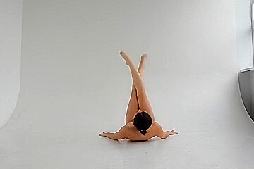 young nude gymnast twisting her well shaped body 