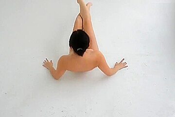 young nude gymnast twisting her well shaped body 